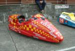 Andrew Couper/Alan Robertson's sidecar at the TT Grandstand, Douglas.