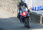 Bruce Anstey approaching the winners' enclosure at the TT Grandstand.