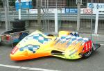 Allan Schofield/Mark Cox's sidecar at the TT Grandstand, Douglas.