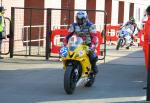 Frank Spenner (62) at the TT Grandstand, Douglas.