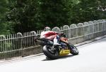 John McGuinness approaching Braddan Bridge.