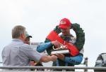 Ryan Farquhar on the winners podium at the TT Grandstand.